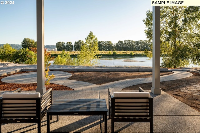 view of property's community with a patio area and a water view