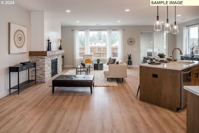 interior space featuring a fireplace, light hardwood / wood-style floors, and sink