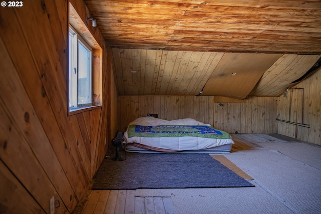 bedroom featuring lofted ceiling, wooden walls, wood ceiling, and hardwood / wood-style flooring