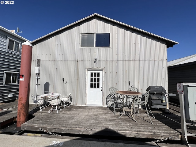 rear view of property featuring a wooden deck