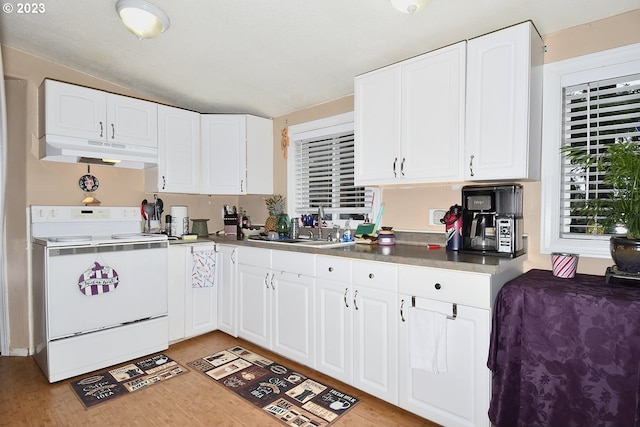 kitchen with electric stove, white cabinets, sink, light hardwood / wood-style flooring, and lofted ceiling