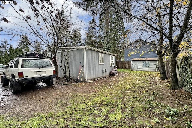 view of side of home featuring a garage and an outdoor structure