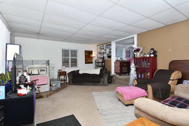 living room with carpet floors and a paneled ceiling