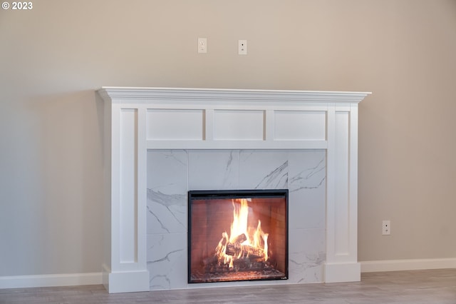 room details featuring light hardwood / wood-style flooring and a tile fireplace