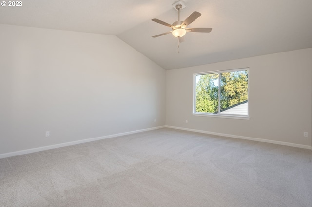 unfurnished room with light carpet, vaulted ceiling, and ceiling fan