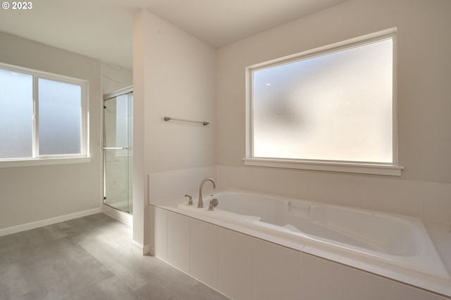 bathroom featuring separate shower and tub