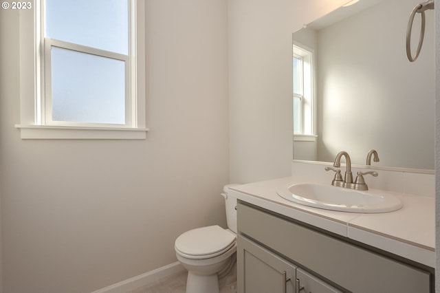 bathroom featuring toilet and vanity