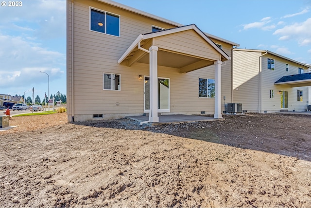 exterior space with central AC unit and a patio