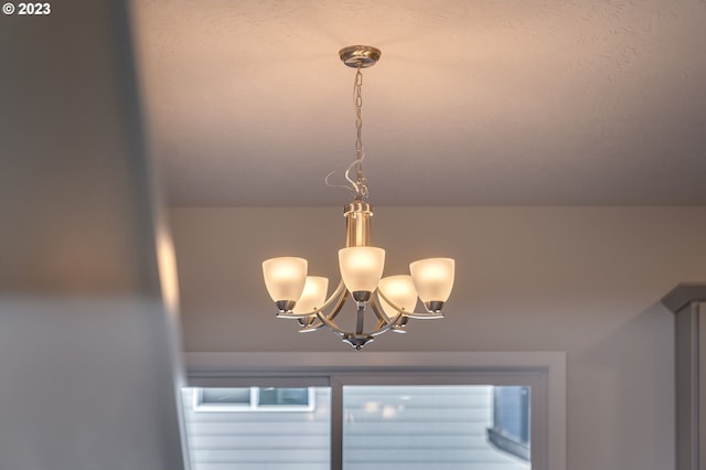 interior details featuring a notable chandelier