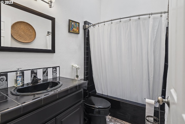 full bathroom featuring tile flooring, large vanity, shower / bath combo with shower curtain, and toilet