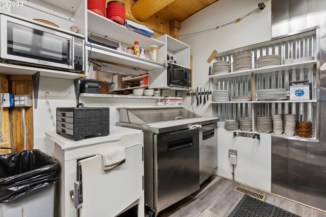 363 S Mill St, Sumpter, OR 97877 - kitchen featuring stainless steel microwave, dark wood-type flooring, and wood ceiling