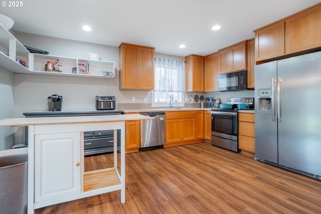 kitchen with light wood-style flooring, appliances with stainless steel finishes, light countertops, open shelves, and recessed lighting