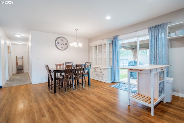 dining space featuring a chandelier, recessed lighting, wood finished floors, and baseboards