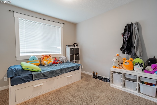 carpeted bedroom featuring baseboards