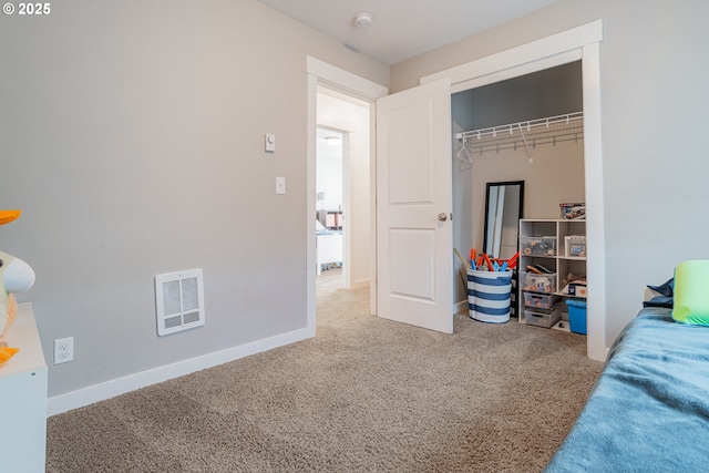 bedroom featuring a closet, baseboards, visible vents, and carpet flooring