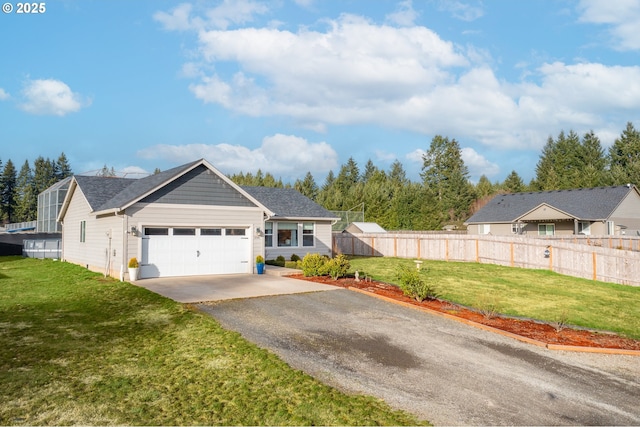 single story home featuring an attached garage, driveway, a front lawn, and fence