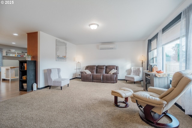 living area featuring carpet, baseboards, an AC wall unit, and recessed lighting