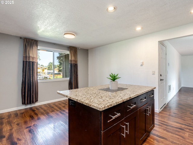 10204 NE 6th Ave, Vancouver, WA 98685 - kitchen featuring dark wood-style floors, a textured ceiling, a center island, recessed lighting, and light stone countertops