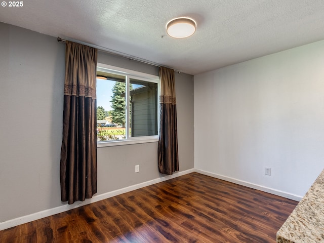 10204 NE 6th Ave, Vancouver, WA 98685 - spare room featuring dark wood-style flooring and a textured ceiling