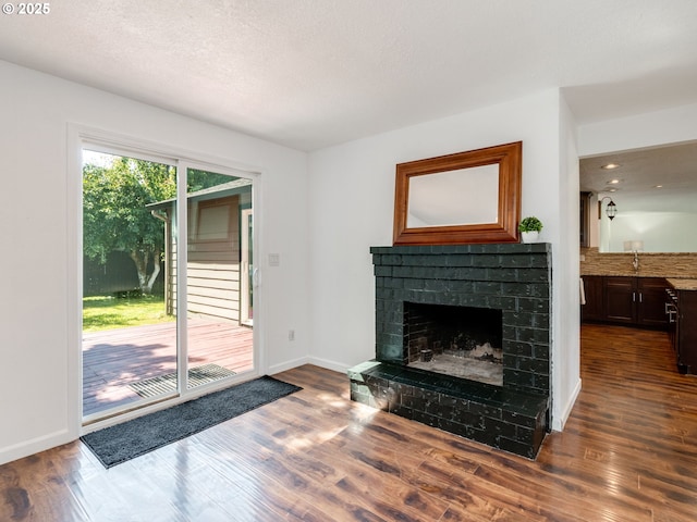 10204 NE 6th Ave, Vancouver, WA 98685 - unfurnished living room featuring a fireplace and dark wood-type flooring
