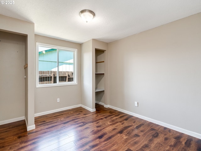 10204 NE 6th Ave, Vancouver, WA 98685 - unfurnished bedroom featuring dark wood finished floors, a textured ceiling, and a closet