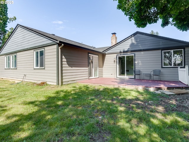 10204 NE 6th Ave, Vancouver, WA 98685 - back of property with a chimney, a lawn, and a patio area