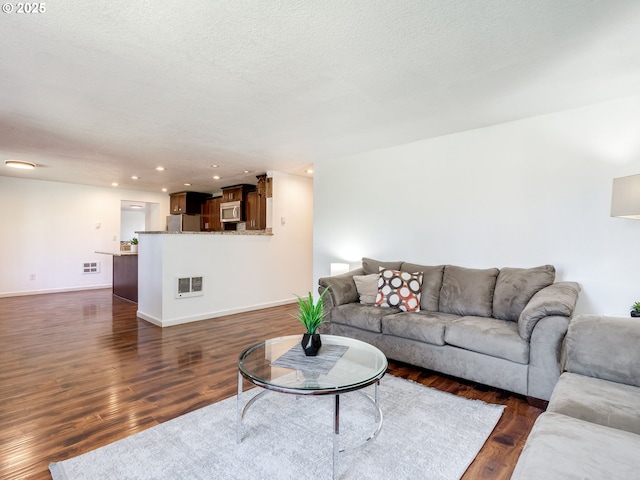 10204 NE 6th Ave, Vancouver, WA 98685 - living room with dark wood-type flooring, recessed lighting, and a textured ceiling