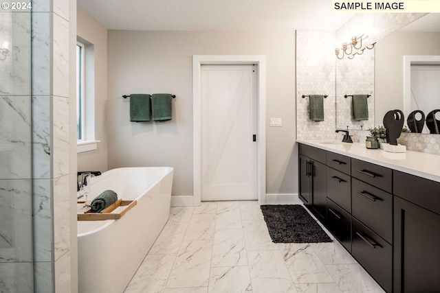 bathroom with tile patterned flooring, a bathing tub, and vanity