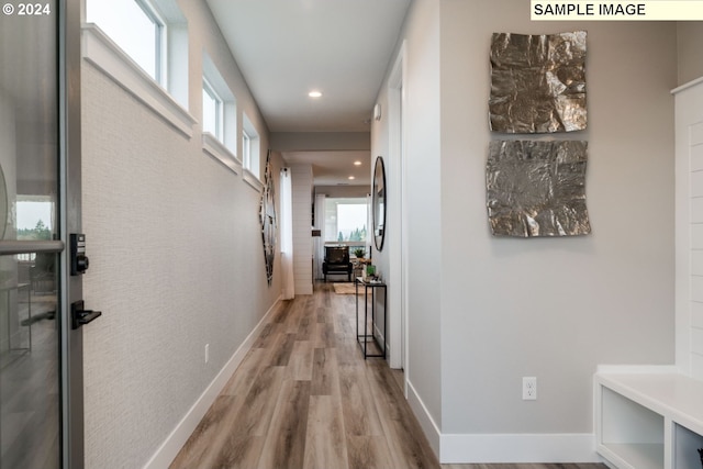 corridor with light hardwood / wood-style floors