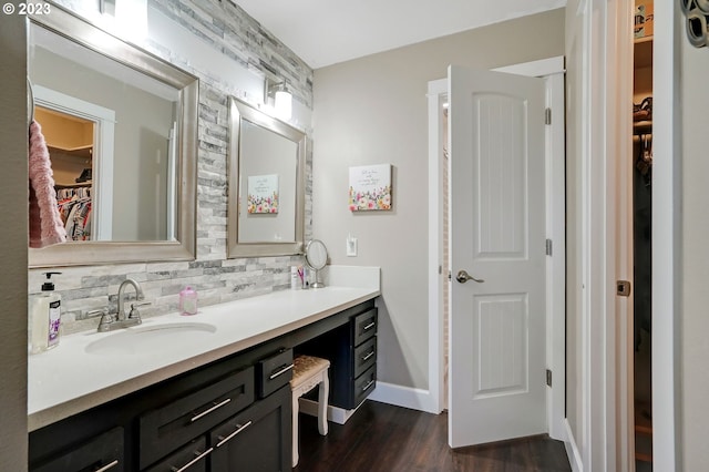 bathroom featuring tasteful backsplash, wood-type flooring, and vanity