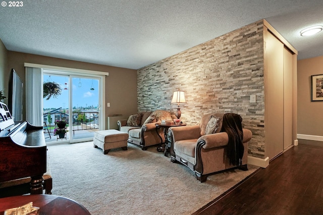 living room with dark carpet and a textured ceiling