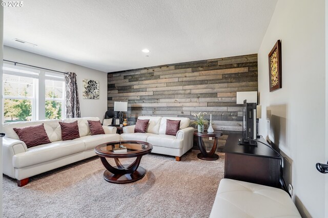 10703 NW Glenmore Way, Portland, OR 97229 - carpeted living area with wood walls, recessed lighting, an accent wall, and a textured ceiling