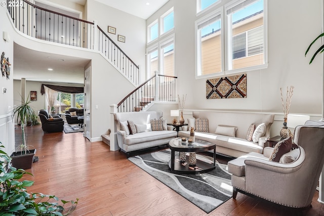 10703 NW Glenmore Way, Portland, OR 97229 - living room with a towering ceiling, wood finished floors, and stairway