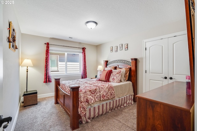 10703 NW Glenmore Way, Portland, OR 97229 - bedroom with light carpet, a closet, and a textured ceiling