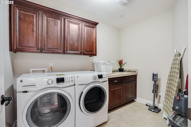 10703 NW Glenmore Way, Portland, OR 97229 - washroom featuring cabinet space and washer and clothes dryer
