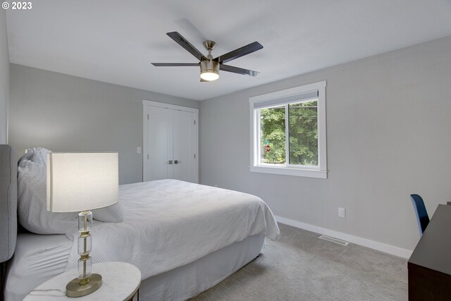 carpeted bedroom with a closet and ceiling fan