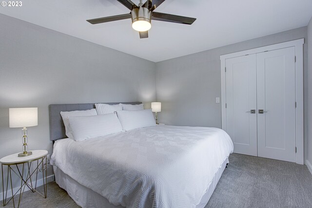 carpeted bedroom featuring ceiling fan and a closet