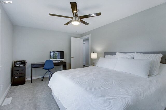 bedroom with ceiling fan and light colored carpet