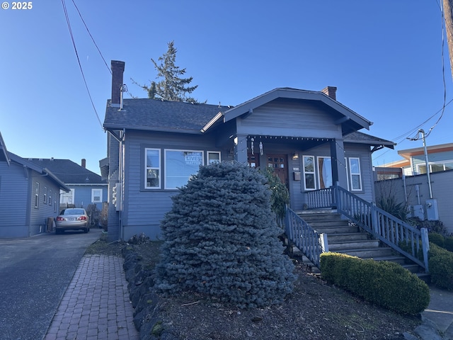 bungalow-style house featuring a chimney