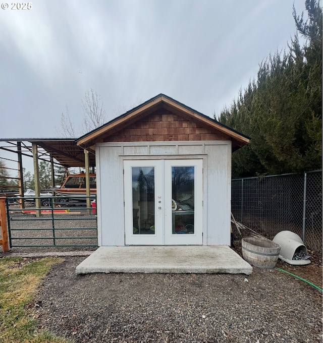 view of outbuilding featuring an outdoor structure and fence