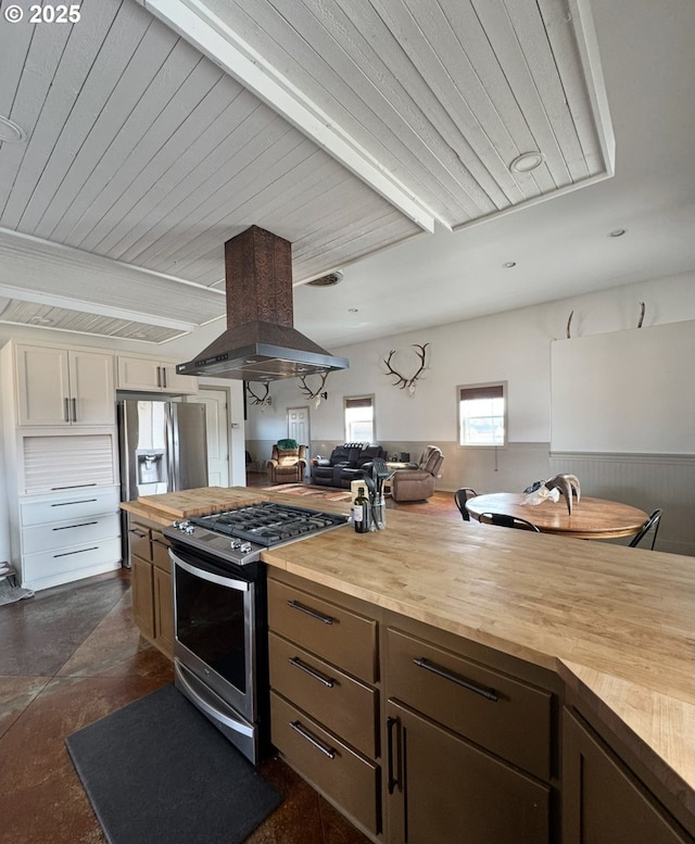 kitchen with wood ceiling, wooden counters, appliances with stainless steel finishes, and island range hood