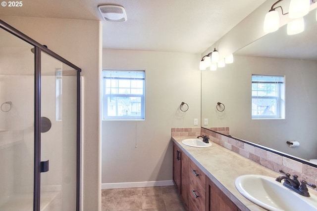 full bath with a sink, visible vents, a stall shower, and double vanity