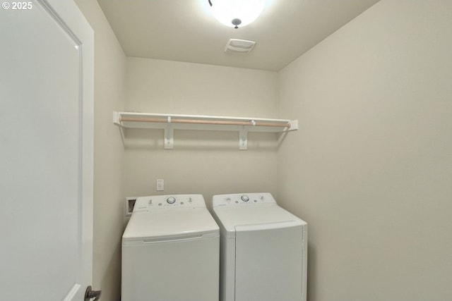 laundry room featuring visible vents, washing machine and dryer, and laundry area