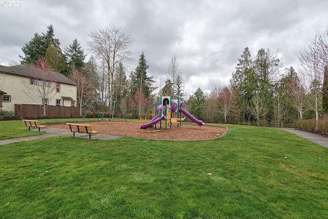 community playground with a yard and fence