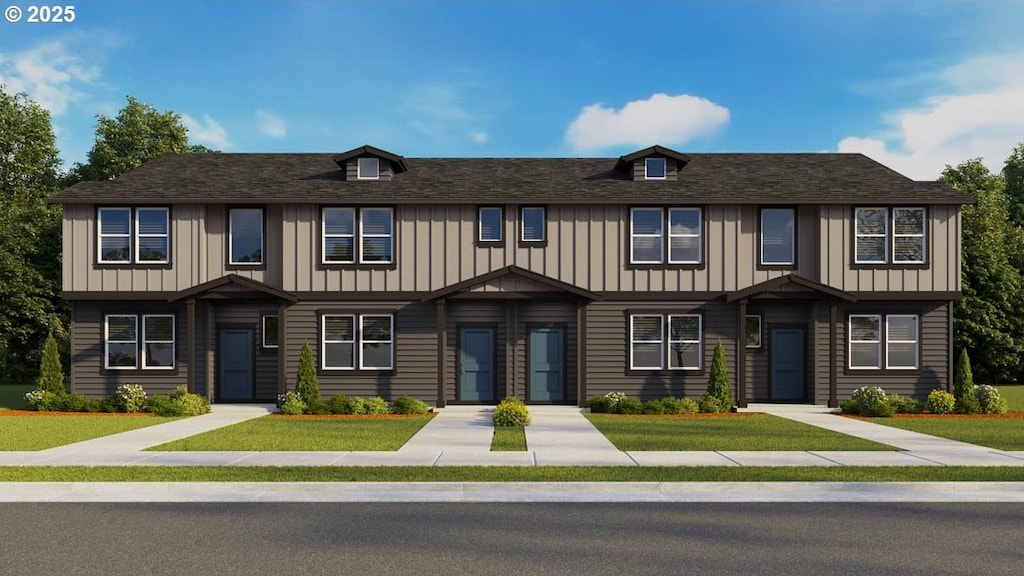 multi unit property with board and batten siding and a front lawn