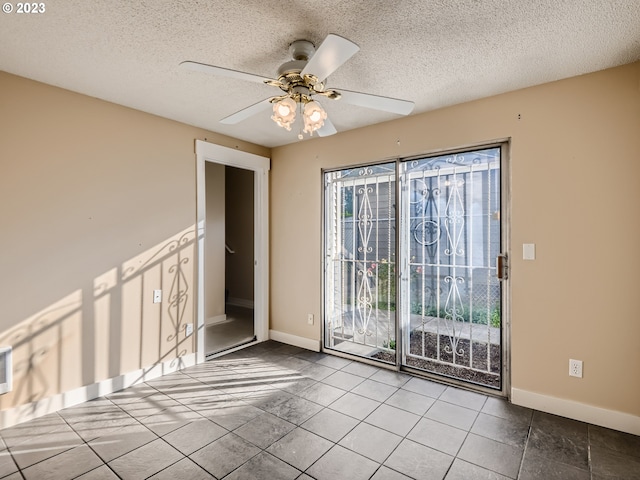 unfurnished room featuring light tile floors, a textured ceiling, and ceiling fan