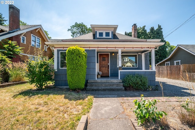 bungalow with a front yard and a porch