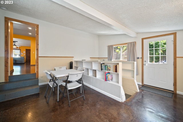 dining room featuring ceiling fan, a textured ceiling, and lofted ceiling with beams