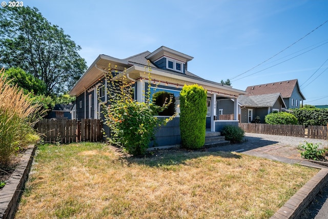 bungalow-style house with a front lawn