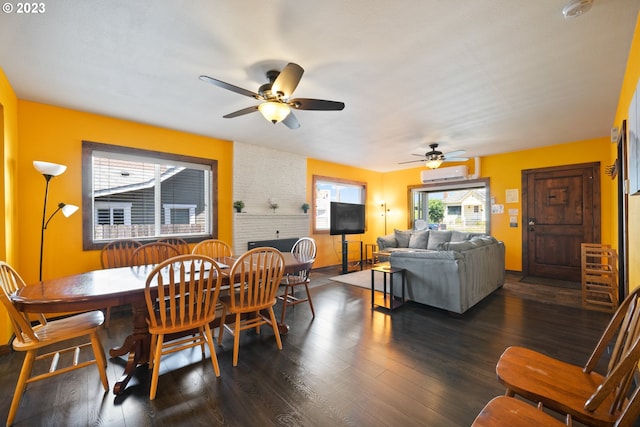 dining space featuring dark hardwood / wood-style flooring, ceiling fan, brick wall, and a wall mounted AC